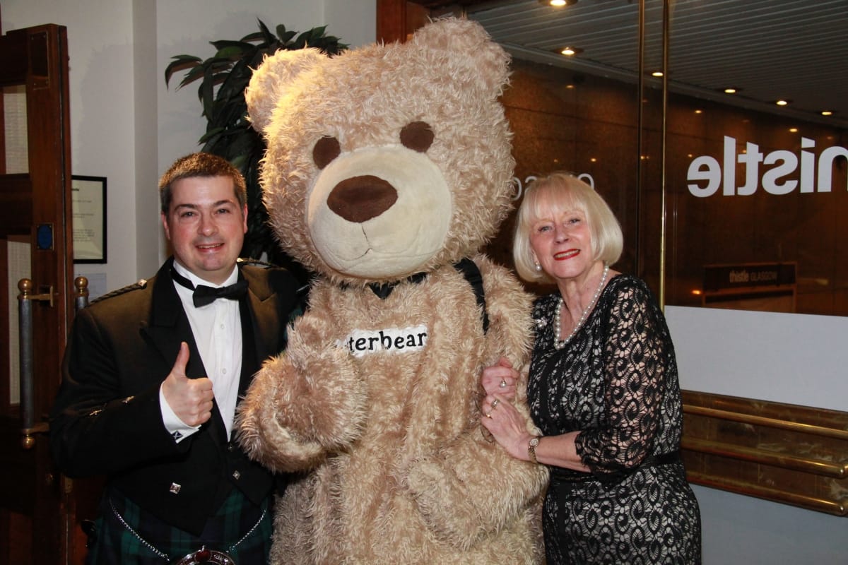 Baxterbear enjoying the evening with John Barr, Baxterbear’s Travel Ambassador and Janice Dickson M.D of Ian Dickson Travel